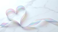 Iridescent ribbon twisted into a heart shape on a white marble surface, soft pastel rainbow shimmer, elegant romantic decor concept.