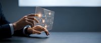 Businessman hands typing on transparent futuristic holographic keyboard with glowing interface elements in modern office environment for technology concepts.
