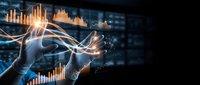 Business professional analyzing financial data with glowing charts and graphs in modern digital interface for investment and market research presentations.