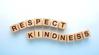 Wooden letter blocks spelling respect and kindness on blue gradient background for motivational and inspirational content.
