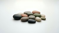 Smooth river stones in neutral earth tones arranged on white background, isolated and ready for design projects, spa concepts, wellness graphics, and decorative applications.