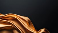 Flowing golden silk fabric with smooth waves and lustrous sheen against dark background, suitable for luxury, fashion, and textile design projects.