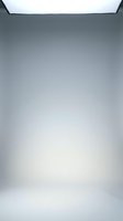 Empty modern studio room with white floor and ceiling light for product photography and commercial shoots.