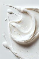 Swirling white cream texture with smooth glossy surface and delicate ripples creates luxurious cosmetic or culinary background for beauty and food industry designs.