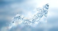 Dynamic water splash creating upward arrow shape against soft blue sky background. Crystal clear liquid motion with droplets and spray for business growth concepts.