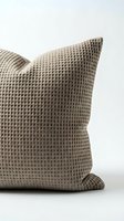 Taupe waffle-knit throw pillow with textured fabric detail, isolated on white background for home decor and interior design use.