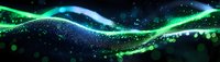 Glowing green and blue waves of light particles flow across dark background creating magical atmospheric effect with bokeh and sparkles. Suitable for tech designs.