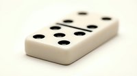 Ivory domino tile with black dots arranged in classic game pattern, isolated on white background for design and gaming projects.