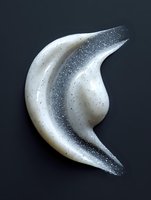 Artistic white crescent moon shape with silver glitter texture against dark background, isolated design element for creative projects and celestial themes.