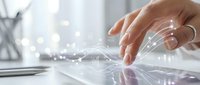 Hand touching digital interface with glowing network connections and data visualization effects on modern workspace background for technology concepts.