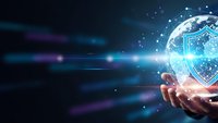 Digital cybersecurity shield protection concept with glowing holographic security icon floating above human hand on futuristic technology background.