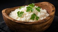 Cooked white rice in wooden bowl garnished with fresh parsley leaves on dark background for healthy meal preparation and cooking concepts.