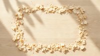 Scattered crushed powder forming rectangular frame on neutral beige surface with shadow overlay, isolated design element for cosmetics, beauty, skincare product mockups, and packaging presentations.