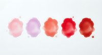 Watercolor paint blobs in pink and red tones on white paper. Abstract artistic stains for creative projects and design elements.