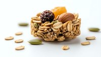Homemade granola bar with nuts, dried fruits and seeds on white background. Healthy snack food for breakfast, diet and fitness nutrition concepts.