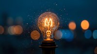 Glowing incandescent bulb with warm filament against blurred city lights at night, symbolizing innovation, ideas, and energy solutions for creative projects.