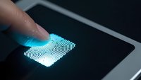 Finger touching glowing blue fingerprint scanner on modern tablet screen for biometric security authentication and digital identity verification access.