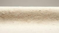 Natural beige linen fabric texture with visible weave pattern and organic fibers creating rustic textile background for interior design projects.