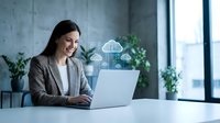 Professional businesswoman using laptop with cloud computing technology icons in modern office environment for digital transformation and data management.