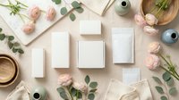 Elegant white gift boxes arranged with pink roses and eucalyptus branches on neutral background for wedding, celebration or luxury packaging design.