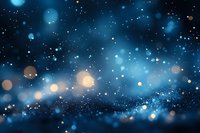 Magical blue bokeh lights and sparkles on dark background create dreamy night sky atmosphere with glowing particles and blurred stars effect.