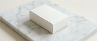 White blank cardboard box on marble surface, minimalist product mockup for branding, packaging design, and label presentation.