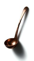 Vintage copper ladle with hammered texture and patina finish, featuring long handle and rounded bowl for serving soups, broths, and sauces in culinary and home decor applications.
