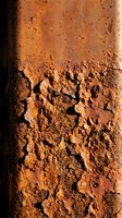 Cracked and weathered rust-colored surface with deep fissures and textured patterns, showing aged deterioration and natural wear. Suitable for backgrounds, textures, and industrial design projects.