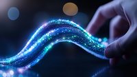 Digital hand touching glowing particle wave with blue and green lights on dark background for technology and innovation concepts.