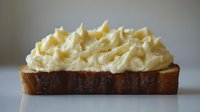 Creamy mashed potatoes generously piped on toasted bread slice creating comfort food appetizer or side dish for restaurant menu and home cooking.