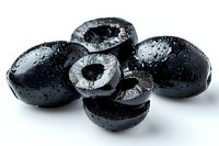 Fresh black olives with water drops on white background, cut and whole pieces showing pits, macro food photography for culinary and Mediterranean cuisine.