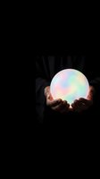Person holding glowing orb with pastel rainbow light gradient against dark background, suitable for mystical, spiritual, magic, future vision, innovation, and technology concepts.