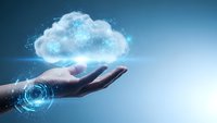 Hand holding glowing cloud with digital particles representing cloud computing technology and data storage solutions for modern business applications.