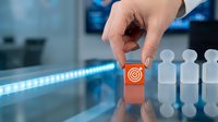 Hand selecting target icon from row of people figures on modern office desk. Business targeting and customer selection strategy concept for marketing campaigns.