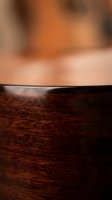 Close-up detail of rich mahogany wood grain texture with warm brown tones and natural patterns for luxury furniture and interior design projects.