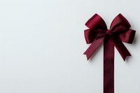 Elegant burgundy satin ribbon bow and straight ribbon on white background, isolated decorative element for gift wrapping and festive design projects.