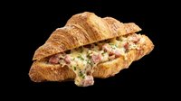 Croissant sandwich with ham, cheese and lettuce filling isolated on transparent background, ready for menu design, food packaging, restaurant graphics, print-on-demand products and culinary marketing materials.