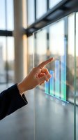 Businesswoman touching interactive holographic bar chart showing quarterly growth data on glass surface in modern office with windows and natural light.