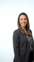 Professional businesswoman in gray suit smiling confidently on white background isolated for corporate marketing and business presentations.