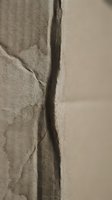 Deep crack in weathered concrete wall showing structural damage and aging deterioration in neutral tones for construction and repair concepts.