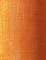 Orange woven fabric texture with detailed close-up view showing individual threads and textile pattern in warm sunlight, creating depth and dimension.