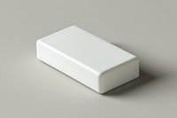 White rectangular block on neutral background with soft shadow, minimalist product mockup for packaging design and branding presentations.