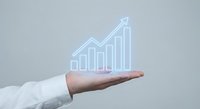 Business professional hand presenting glowing growth chart with upward arrow showing financial success and progress on neutral background.