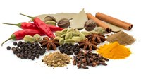 Colorful aromatic spices and herbs collection with red chili peppers, cinnamon sticks, cardamom, star anise, turmeric powder on white background.
