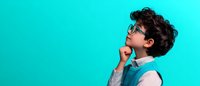 Young Asian male professional in business casual attire with glasses and curly hair thinking deeply against turquoise background, profile view showing contemplative expression.