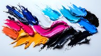 Vibrant oil paint smears in blue, pink, orange and black colors on white surface create dynamic abstract composition with textured brushstrokes and artistic movement.
