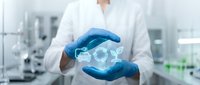 Healthcare professional in blue gloves holding holographic brain model in modern medical laboratory for neuroscience research and medical technology applications.