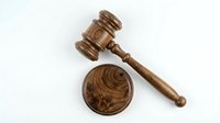Wooden judge gavel and sound block isolated on white background for legal justice court law auction decisions.