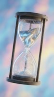 Magical hourglass with glittering sand flowing through glass bulbs on dreamy pastel background for time management and fantasy concepts.