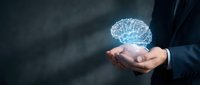 Businessman holding glowing digital brain hologram in cupped hands representing artificial intelligence, innovation and future technology concepts.